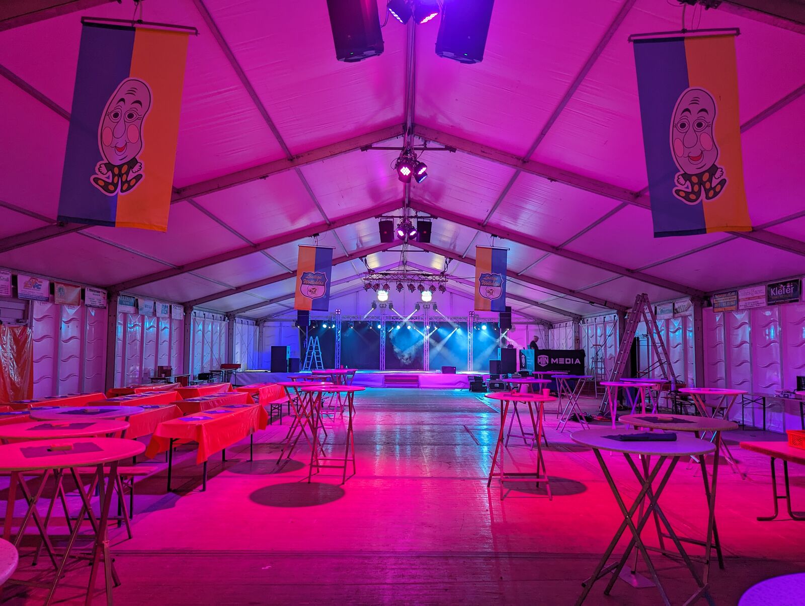 Empty event tent in a magenta lighting wash