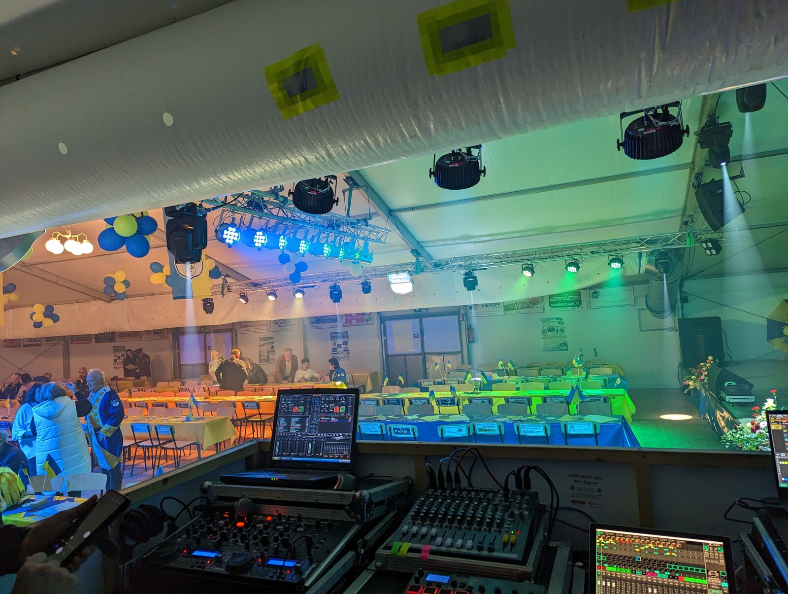 Front-of-house desks during setup with the tent still empty